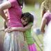Ann Arbor residents Billie Bonevich, 8, hugs her mother, Nikki, during the Arborcrest memorial Day Observance on Sunday, May 26. Daniel Brenner I AnnArbor.com